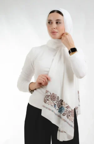 The Joury Ivory Rose Petals Tatreez Shawl is a plush, feather-light embroidered hijab made from crepe fabric with elegant accents—perfect for daily wear and elegant outings.