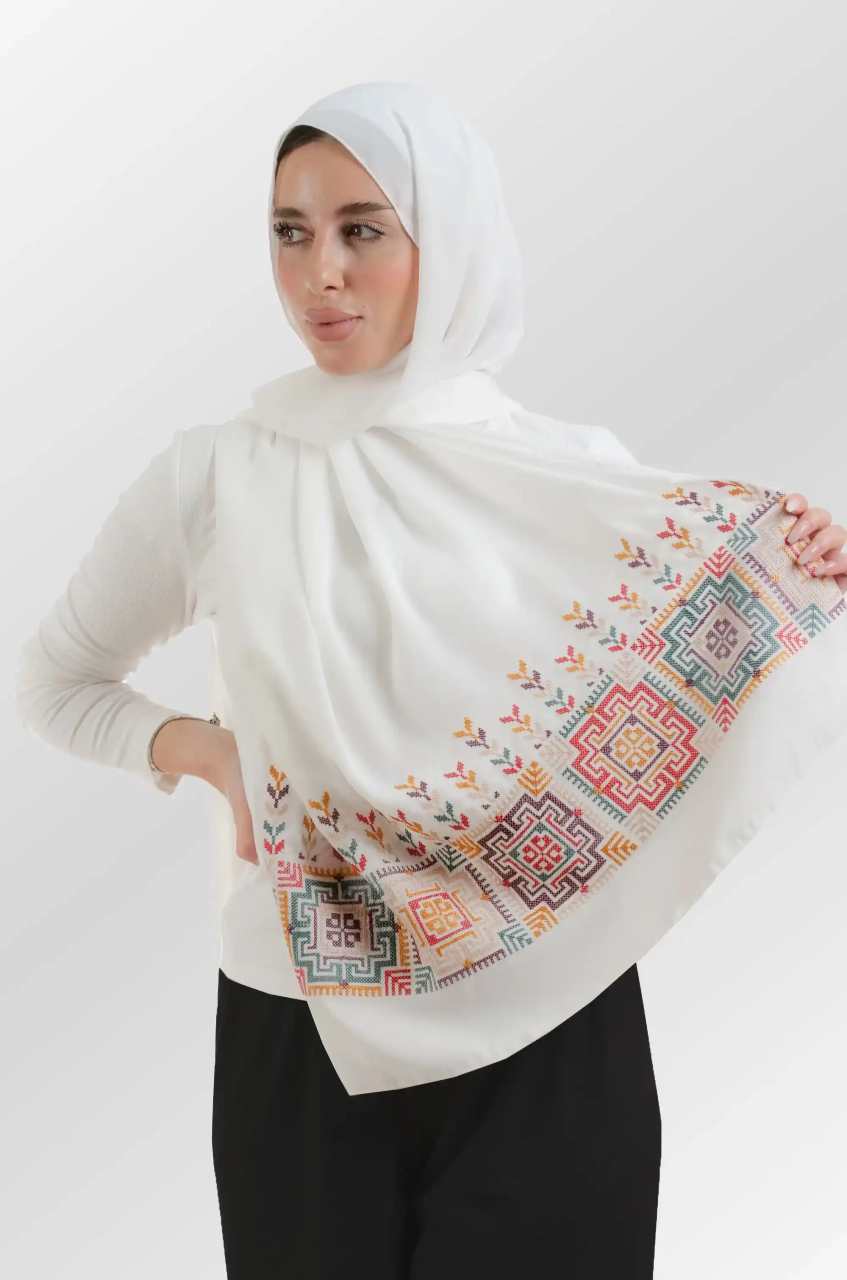 The Fallahi Mix ivory Tatreez Shawl is a cozy, well-ventilated embroidered hijab made from crepe fabric with meticulous handiwork—great for day-to-day wear and celebrations.