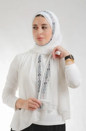 The Sabalah Cream Tatreez Shawl is a plush, feather-light embroidered hijab made from chiffon fabric with elegant accents—perfect for daily wear and elegant outings.