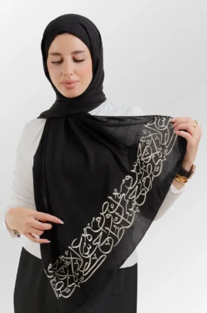 The Ahrof Black Arabic Letters Tatreez Shawl is a gentle, airy embroidered hijab made from crepe fabric with fine craftsmanship—perfect for everyday use and special events.