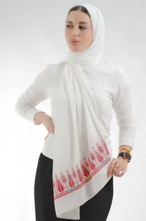 The Sarwat Ivory Cypress Tatreez Shawl is a silky, fresh embroidered hijab made from crepe fabric with delicate stitching—excellent for regular use and dressy affairs.