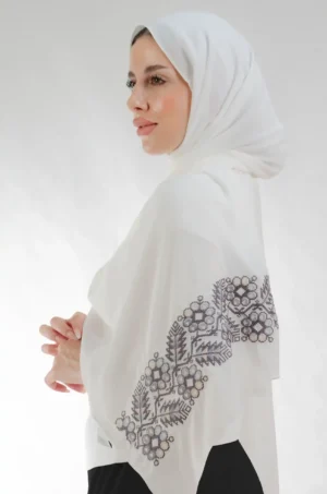 The Pine Cream Tatreez Shawl is a plush, feather-light embroidered hijab made from crepe fabric with elegant accents—perfect for daily wear and elegant outings.