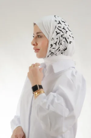 The Printed White Arabic Letters Triangle Shawl is a smooth, light embroidered hijab made from qotton fabric with intricate detailing—suited to both routine wear and festive gatherings.