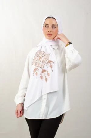 The Sand Bethlehem Tatreez Shawl is a cozy, breathable embroidered hijab made from cotton fabric—perfect for everyday wear and celebrations.