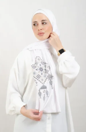 The Navy blue Bethlehem Tatreez Shawl is a cozy, breathable embroidered hijab made from cotton fabric—perfect for everyday wear and celebrations