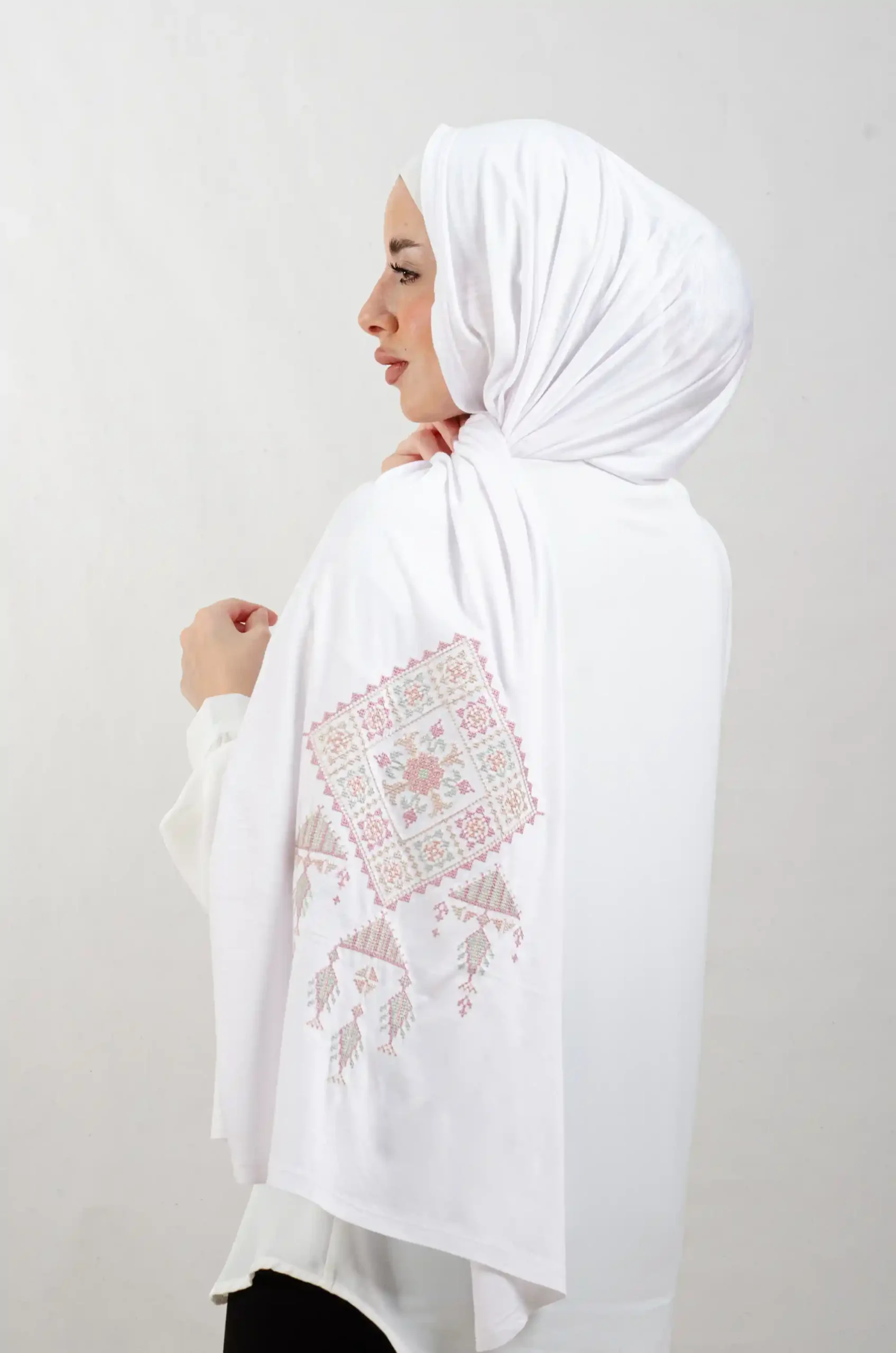 The Rose Bethlehem Tatreez Shawl is a cozy, breathable embroidered hijab made from cotton fabric—perfect for everyday wear and celebrations.
