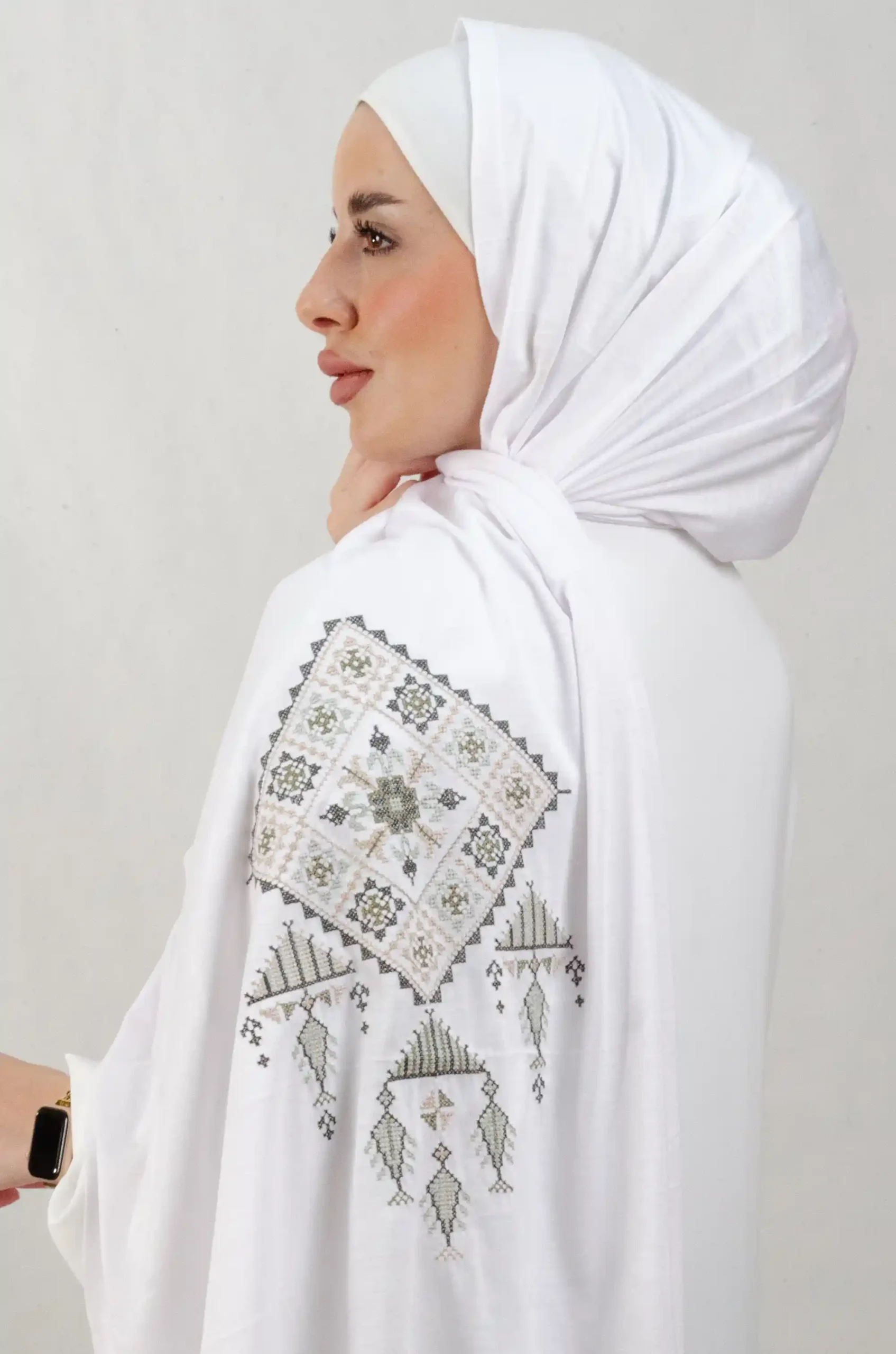 The Olive Bethlehem Tatreez Shawl is a cozy, breathable embroidered hijab made from cotton fabric—perfect for everyday wear and celebrations.