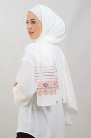 The Beehive-Peach Tatreez Shawl is a cozy, breathable embroidered hijab made from Crepe fabric. Perfect for everyday wear and celebrations.