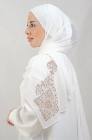 The Nude Color Hebron Tatreez Shawl is a cozy, breathable embroidered hijab made from Georgette chiffon fabric. Perfect for everyday wear and celebrations.