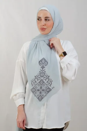 The Blue Hebron Tatreez Shawl is a cozy, breathable embroidered hijab made from Georgette chiffon fabric. Perfect for everyday wear and celebrations.
