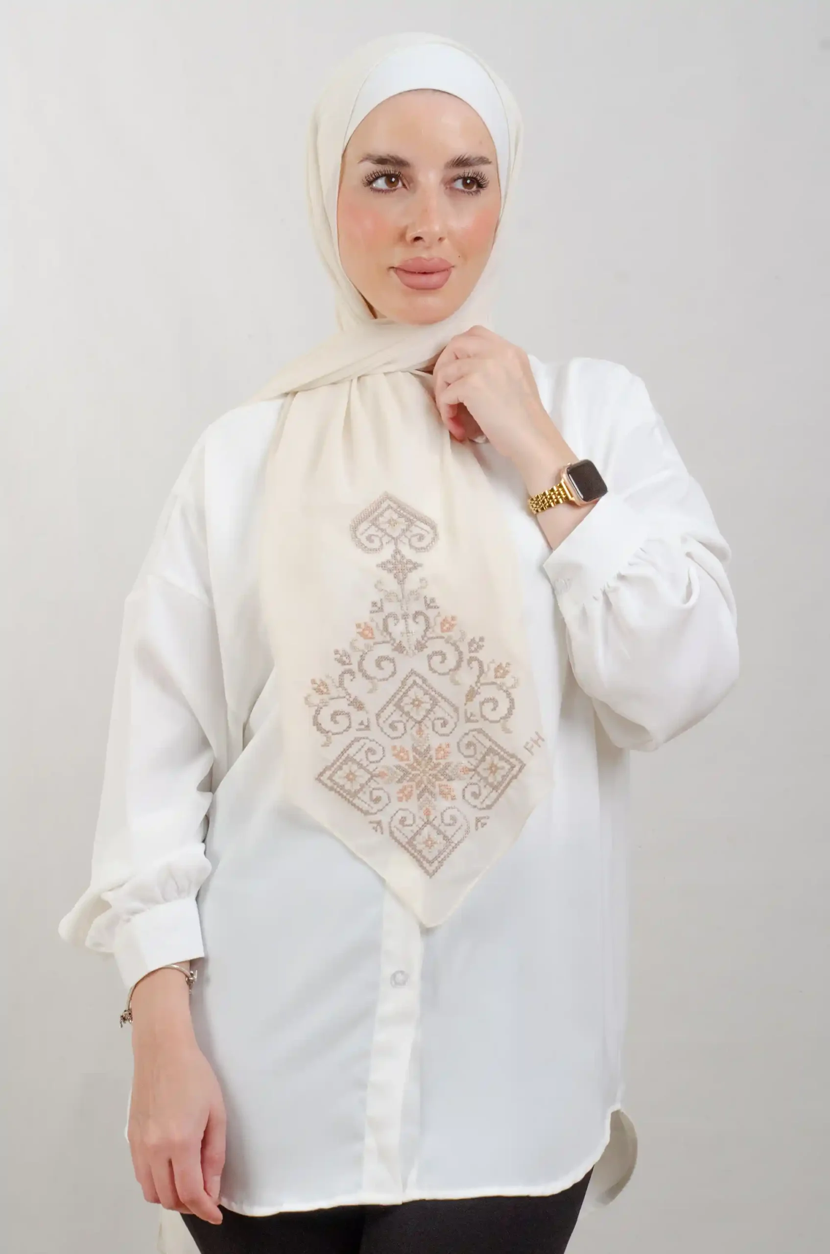The Beige Hebron Tatreez Shawl is a cozy, breathable embroidered hijab made from Georgette chiffon fabric. Perfect for everyday wear and celebrations.