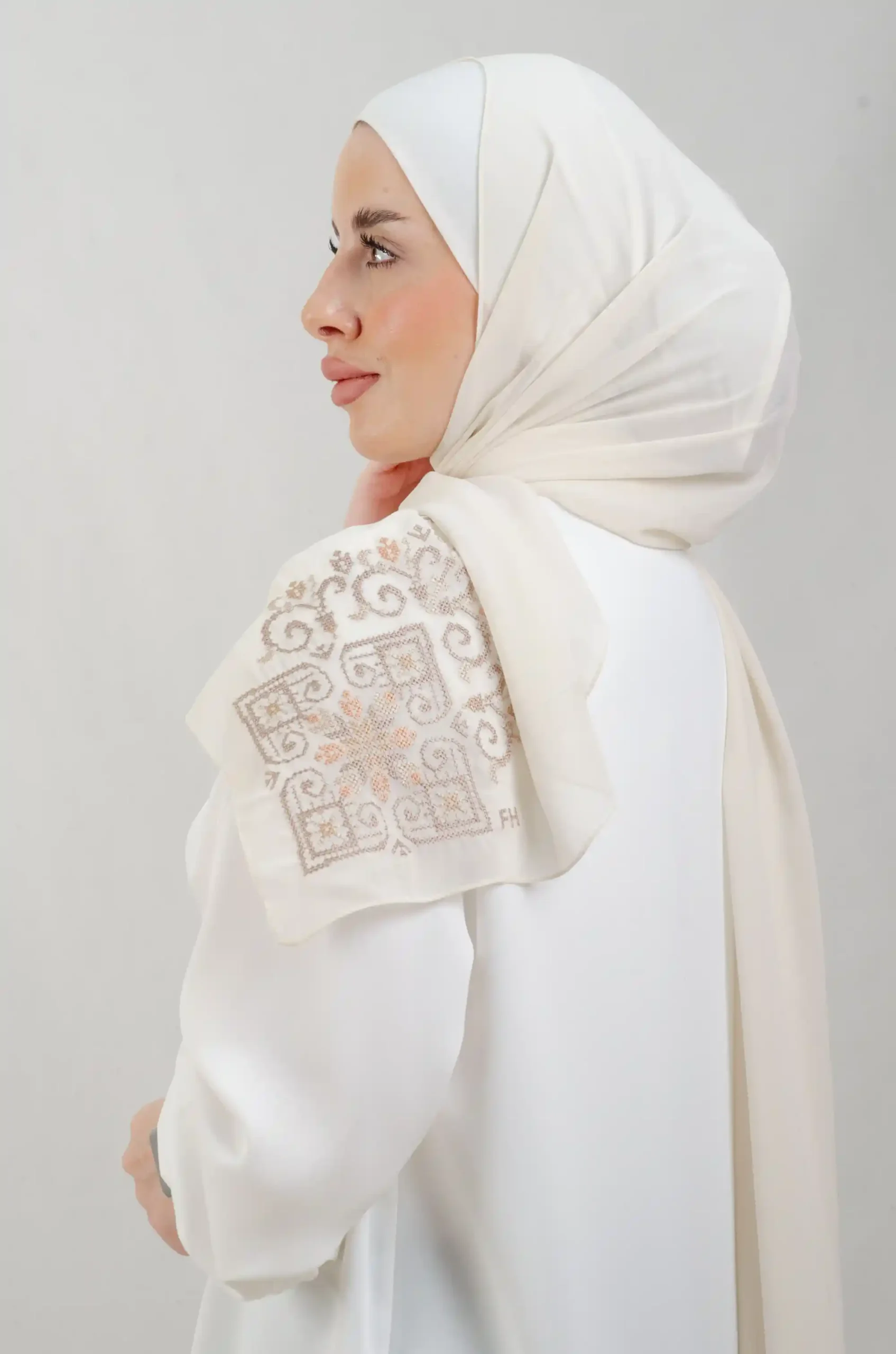 The Beige Hebron Tatreez Shawl is a cozy, breathable embroidered hijab made from Georgette chiffon fabric. Perfect for everyday wear and celebrations.