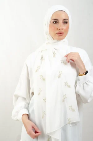 The Lilac Metal Tatreez Shawl is a cozy, breathable embroidered hijab made from Georgette chiffon fabric. Perfect for everyday wear and celebrations.