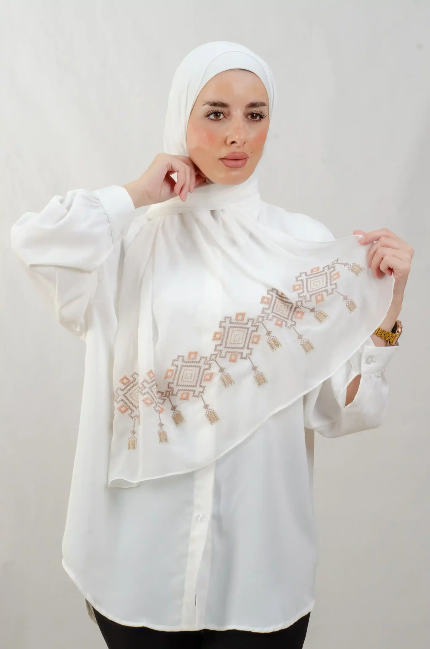 The Chandeliers Sand Tatreez Shawl is a cozy, breathable embroidered hijab made from Georgette chiffon fabric. Perfect for everyday wear and celebrations.