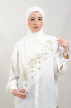 The Chandeliers Gold Tatreez Shawl is a cozy, breathable embroidered hijab made from Georgette chiffon fabric. Perfect for everyday wear and celebrations.
