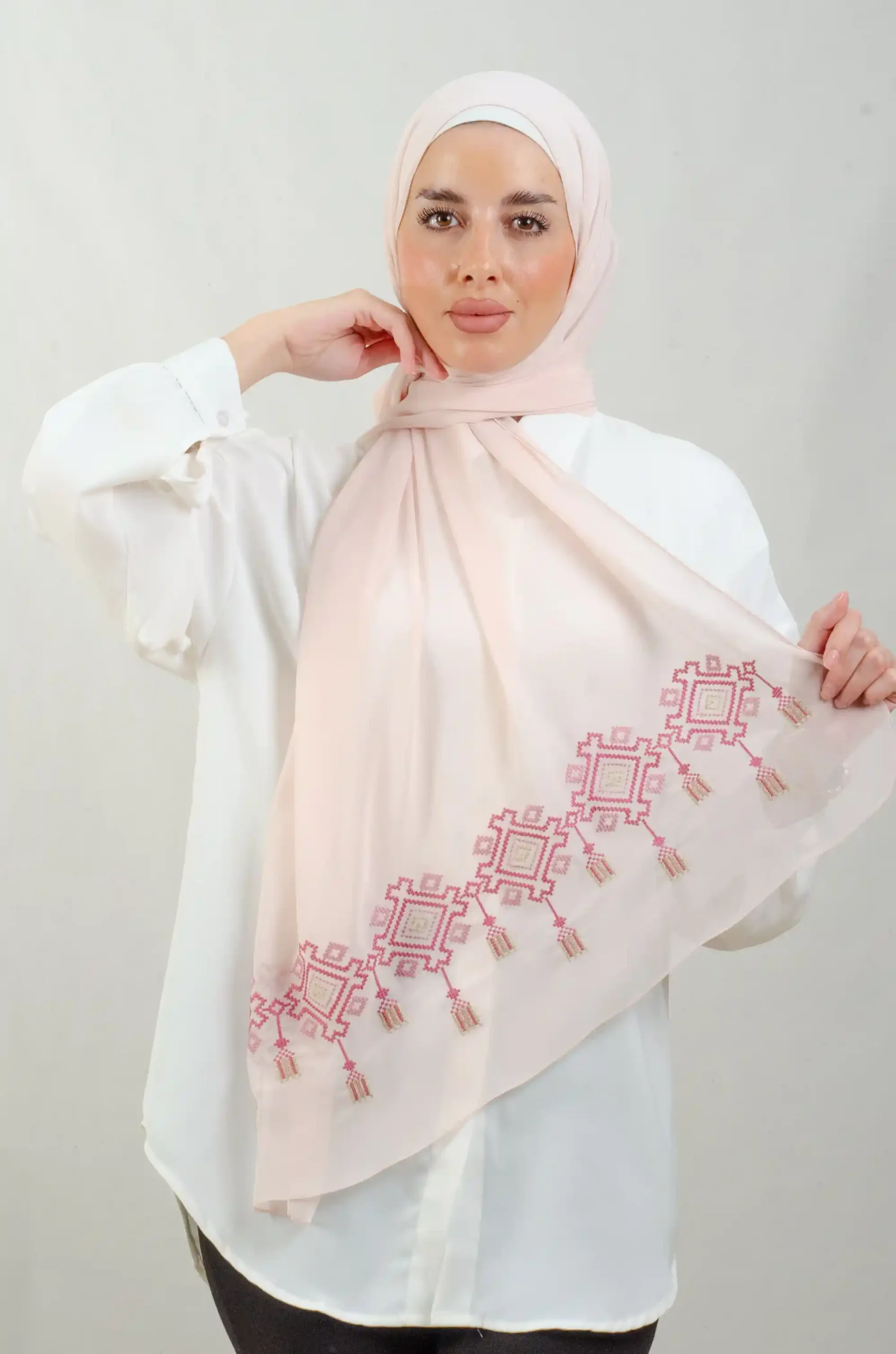 The Chandeliers Rose Tatreez Shawl is a cozy, breathable embroidered hijab made from Georgette chiffon fabric. Perfect for everyday wear and celebrations.