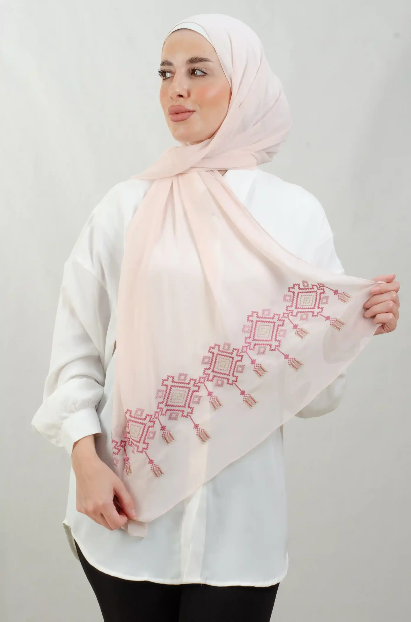 The Chandeliers Rose Tatreez Shawl is a cozy, breathable embroidered hijab made from Georgette chiffon fabric. Perfect for everyday wear and celebrations.