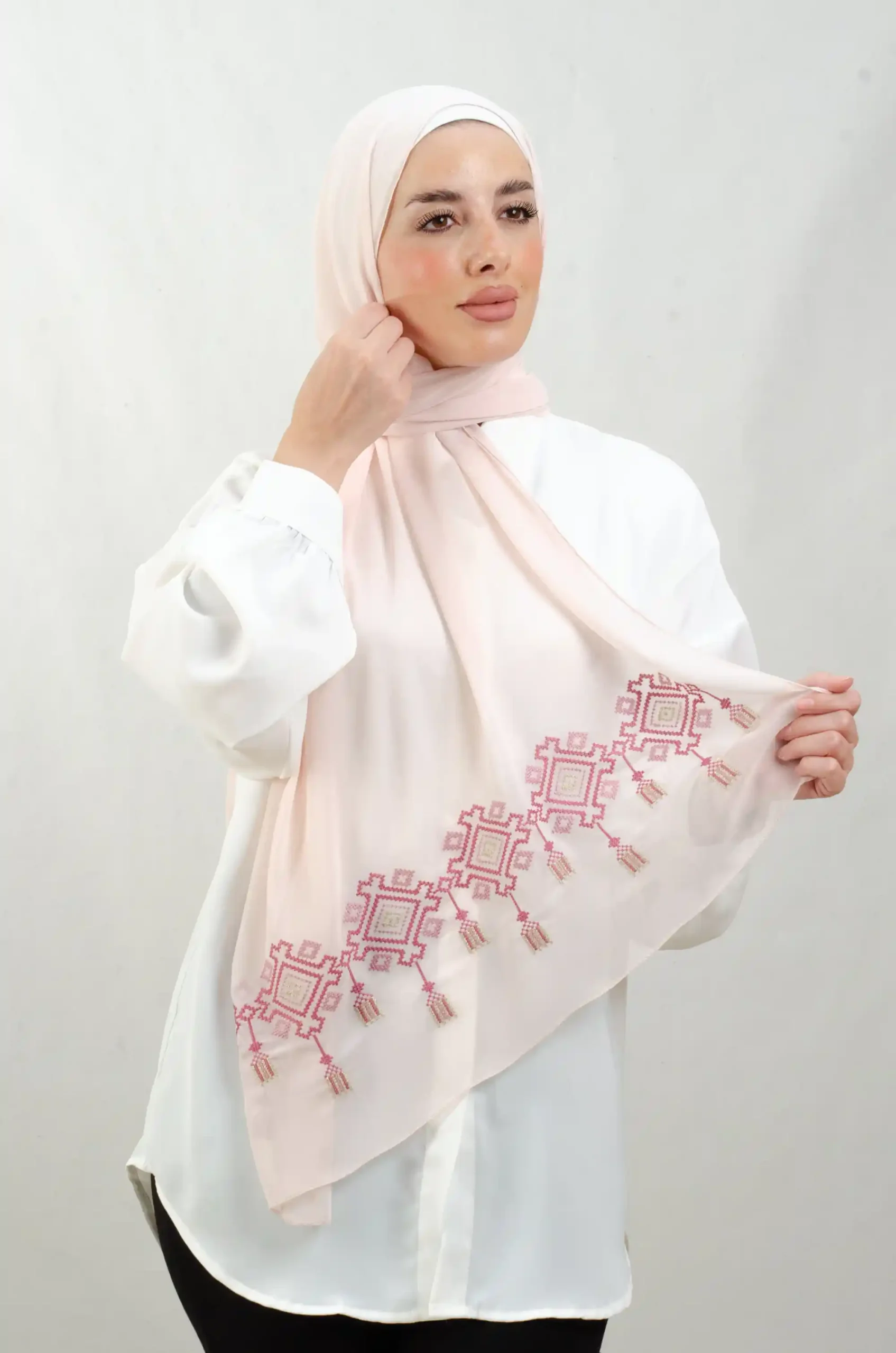 The Chandeliers Rose Tatreez Shawl is a cozy, breathable embroidered hijab made from Georgette chiffon fabric. Perfect for everyday wear and celebrations.