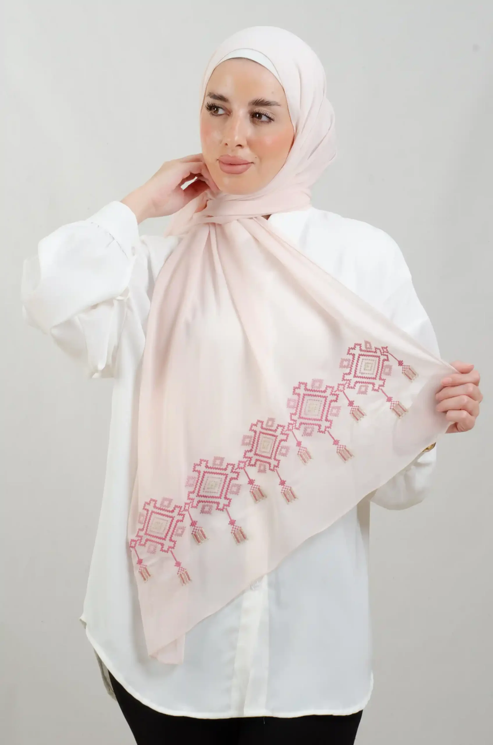 The Chandeliers Rose Tatreez Shawl is a cozy, breathable embroidered hijab made from Georgette chiffon fabric. Perfect for everyday wear and celebrations.
