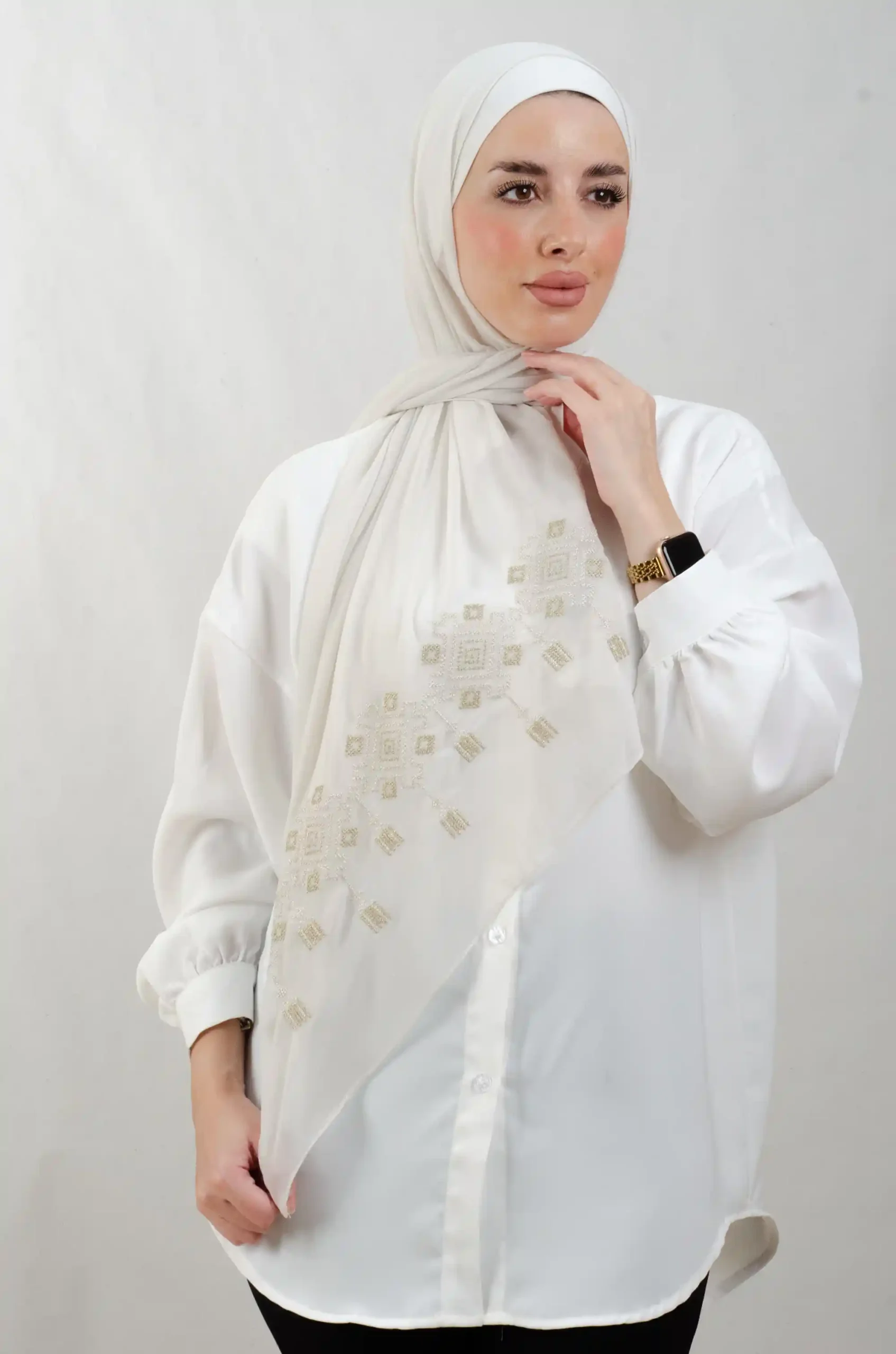 The Chandeliers Metal Tatreez Shawl is a cozy, breathable embroidered hijab made from Georgette chiffon fabric. Perfect for everyday wear and celebrations.