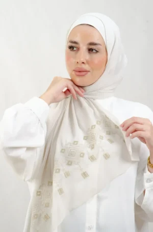 The Chandeliers Metal Tatreez Shawl is a cozy, breathable embroidered hijab made from Georgette chiffon fabric. Perfect for everyday wear and celebrations.