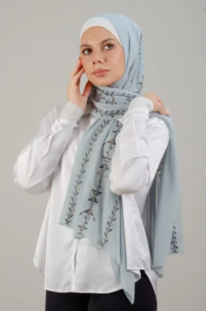 The Cypress Vine Blue Tatreez Shawl is a cozy and breathable embroidered hijab crafted from premium Georgette chiffon fabric. Designed with elegant Tatreez embroidery in Cypress Vine Blue, it offers a graceful drape and lightweight comfort. Perfect for daily wear as well as festive gatherings and celebrations.
