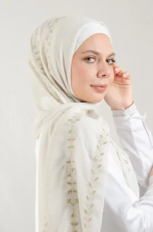 The Cypress Vine Metal Tatreez Shawl is a cozy and breathable embroidered hijab crafted from premium Georgette chiffon fabric. Designed with elegant Tatreez embroidery in Cypress Vine Metal, it offers a graceful drape and lightweight comfort. Perfect for daily wear as well as festive gatherings and celebrations.