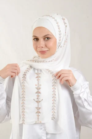 The Cypress Vine Sand Tatreez Shawl is a cozy and breathable embroidered hijab crafted from premium Georgette chiffon fabric. Designed with elegant Tatreez embroidery in Cypress Vine Sand, it offers a graceful drape and lightweight comfort. Perfect for daily wear as well as festive gatherings and celebrations.