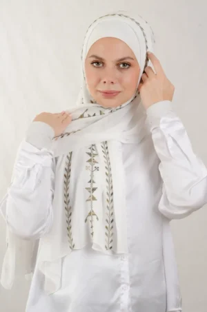 The Cypress Vine Light Olive Tatreez Shawl is a cozy and breathable embroidered hijab crafted from premium Georgette chiffon fabric. Designed with elegant Tatreez embroidery in Cypress Vine Light Olive, it offers a graceful drape and lightweight comfort. Perfect for daily wear as well as festive gatherings and celebrations.