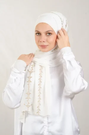 The Cypress Vine Gold Tatreez Shawl is a cozy and breathable embroidered hijab crafted from premium Georgette chiffon fabric. Designed with elegant Tatreez embroidery in Cypress Vine Gold, it offers a graceful drape and lightweight comfort. Perfect for daily wear as well as festive gatherings and celebrations.