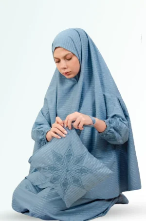 Sujood Blue Prayer Set in Dirty Blue — a coordinated two‑piece prayer set crafted from cotton for a light, breathable drape and modest coverage. Comfortable for sujood and ruku, easy to care for, and travel‑friendly; a practical choice for daily worship at home or the mosque.