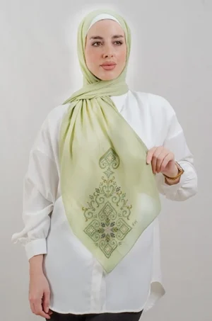 The Green Hebron Tatreez Shawl is a cozy, breathable embroidered hijab made from Georgette chiffon fabric. Perfect for everyday wear and celebrations.