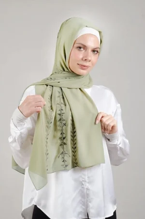 The Cypress Vine Green Tatreez Shawl is a cozy and breathable embroidered hijab crafted from premium Georgette chiffon fabric. Designed with elegant Tatreez embroidery in Cypress Vine Green, it offers a graceful drape and lightweight comfort. Perfect for daily wear as well as festive gatherings and celebrations.