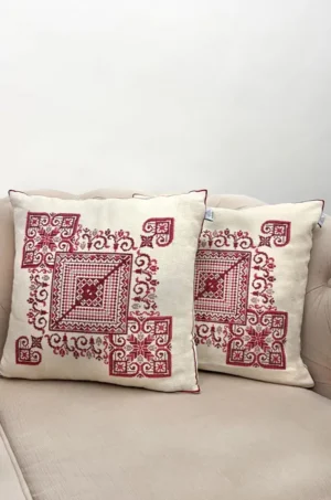 A bold red embroidered cushion cover set that adds richness, heritage, and a striking traditional touch.