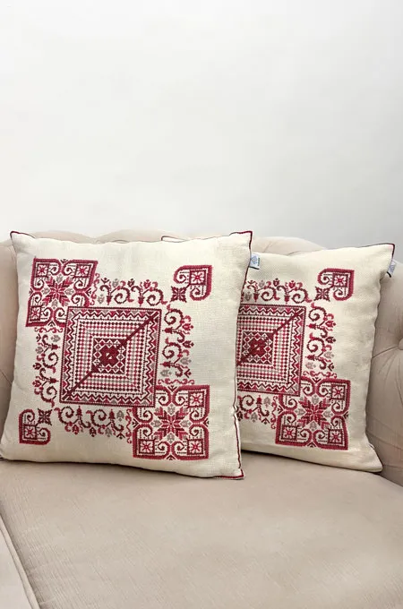 A bold red embroidered cushion cover set that adds richness, heritage, and a striking traditional touch.