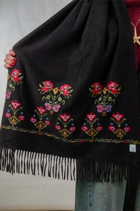 Black Jouri Embroidered Winter Shoulder Shawl in a warm winter design crafted from ultra-soft mohair fabric, featuring Jouri Falahi embroidery in a rich mix of traditional colors, inspired by authentic rural Palestinian heritage.