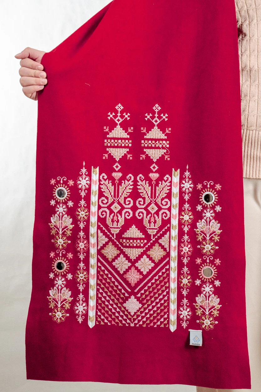 Red Nabati with Snow-White Embroidered Shoulder Shawl in a warm winter design featuring Falahi embroidery, bratto details, and mirror accents inspired by Central Region heritage.