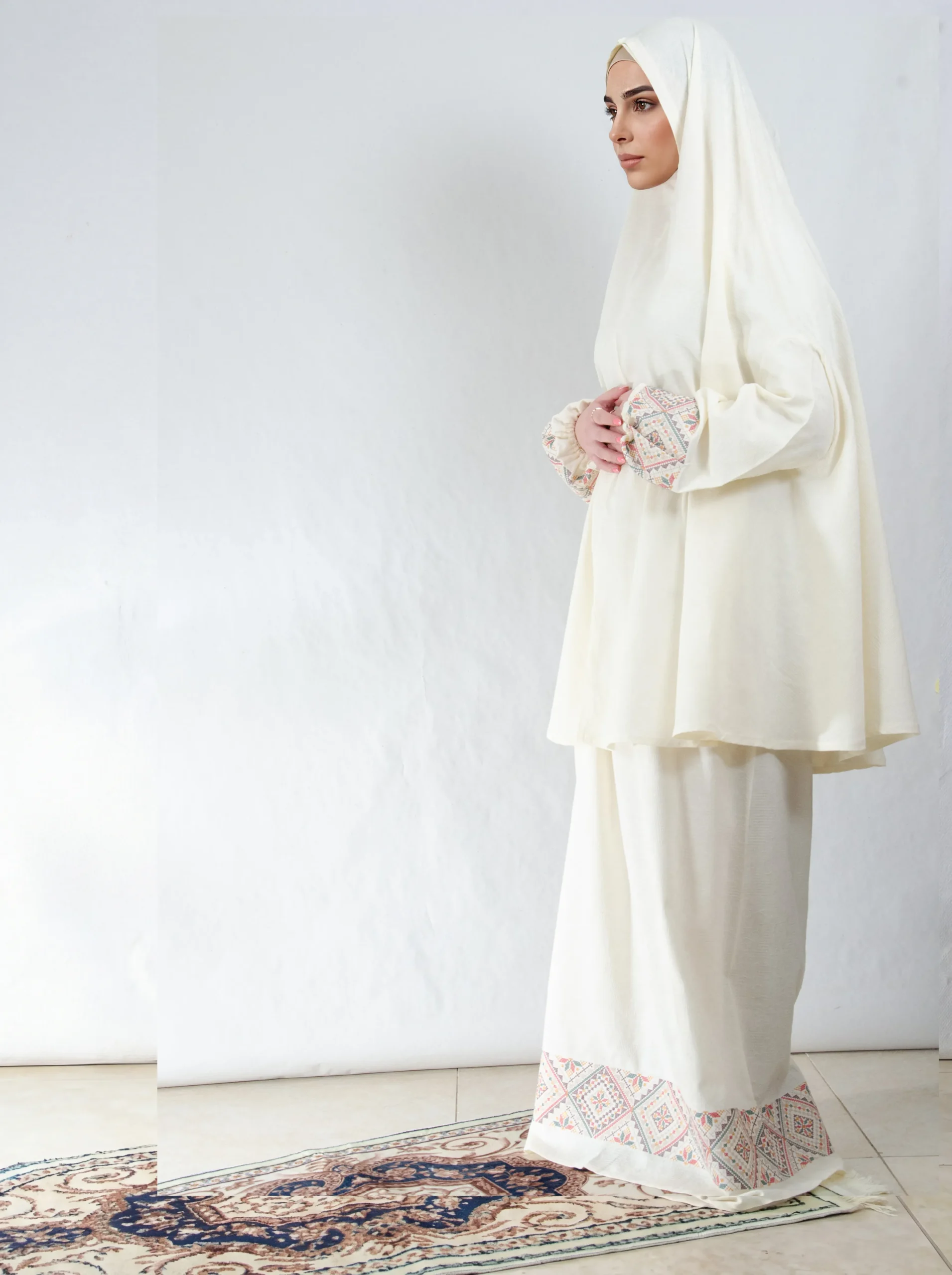 A cream 3-piece Khushoo embroidered prayer set featuring soft fabric and Fallahi embroidery inspired by handcrafted tradition. Designed for serene, elegant prayer moments.