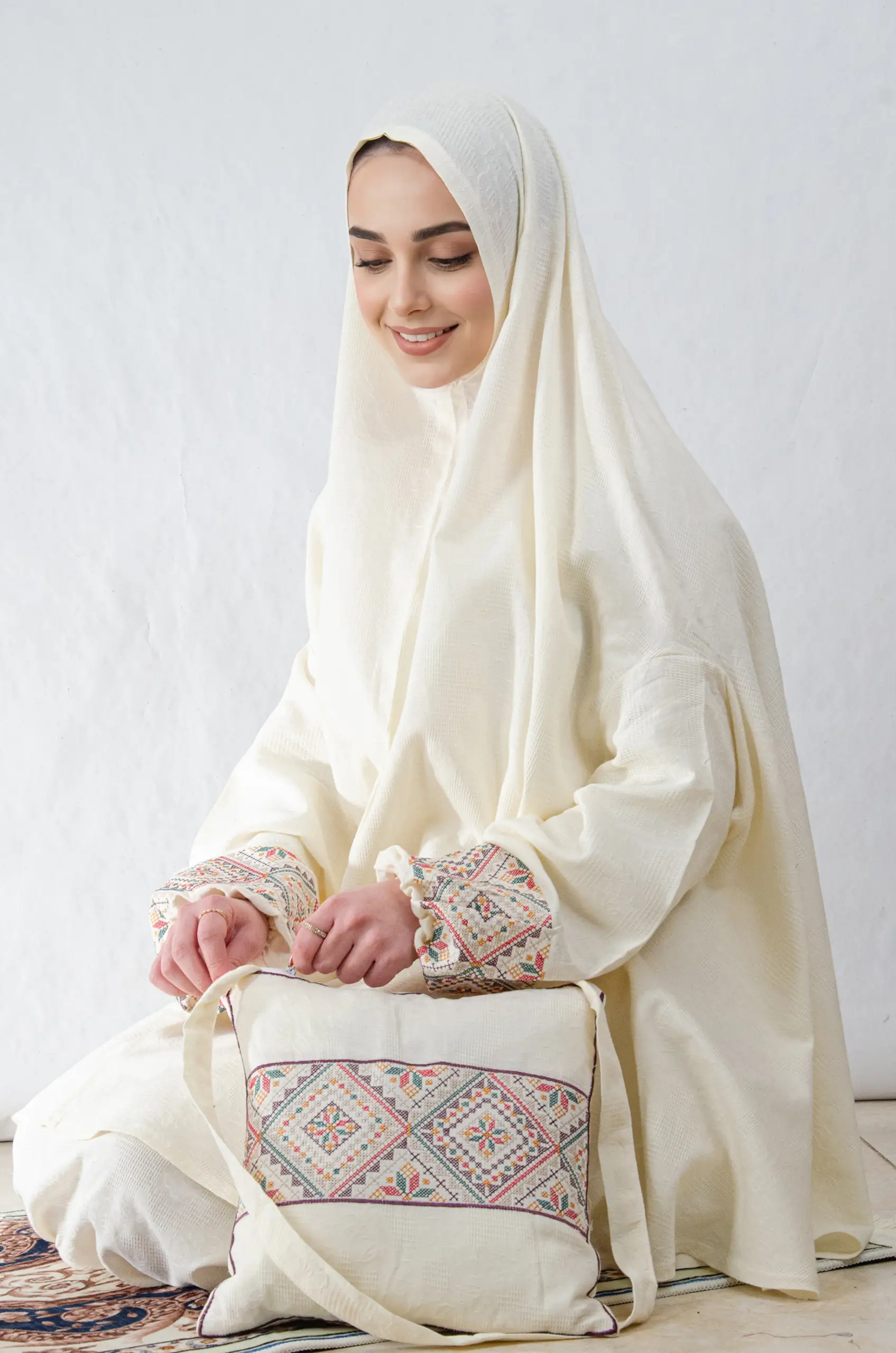 A cream 3-piece Khushoo embroidered prayer set featuring soft fabric and Fallahi embroidery inspired by handcrafted tradition. Designed for serene, elegant prayer moments.