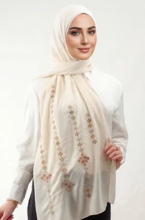 The Beige Taif Embroidered Shawl features traditional fallahi embroidery with refined aghabani detailing. Crafted from lightweight chiffon, this embroidered shawl offers graceful movement and versatile styling while celebrating the beauty of Palestinian تطريز.
