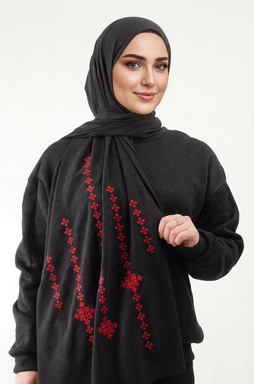 The Black-Red Taif Embroidered Shawl features bold red fallahi embroidery on a classic black chiffon base with refined aghabani detailing. This embroidered shawl offers graceful movement and versatile styling while celebrating the heritage of Palestinian تطريز.