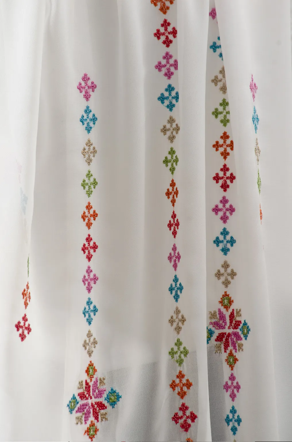 The Cream-Mix Taif Embroidered Shawl features traditional fallahi embroidery in mixed colors on a soft cream chiffon base with refined aghabani detailing. This embroidered shawl offers graceful movement and versatile styling while celebrating the beauty of Palestinian تطريز.