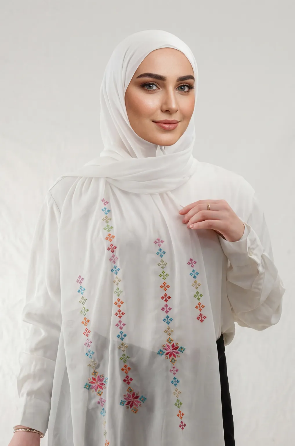 The Cream-Mix Taif Embroidered Shawl features traditional fallahi embroidery in mixed colors on a soft cream chiffon base with refined aghabani detailing. This embroidered shawl offers graceful movement and versatile styling while celebrating the beauty of Palestinian تطريز.