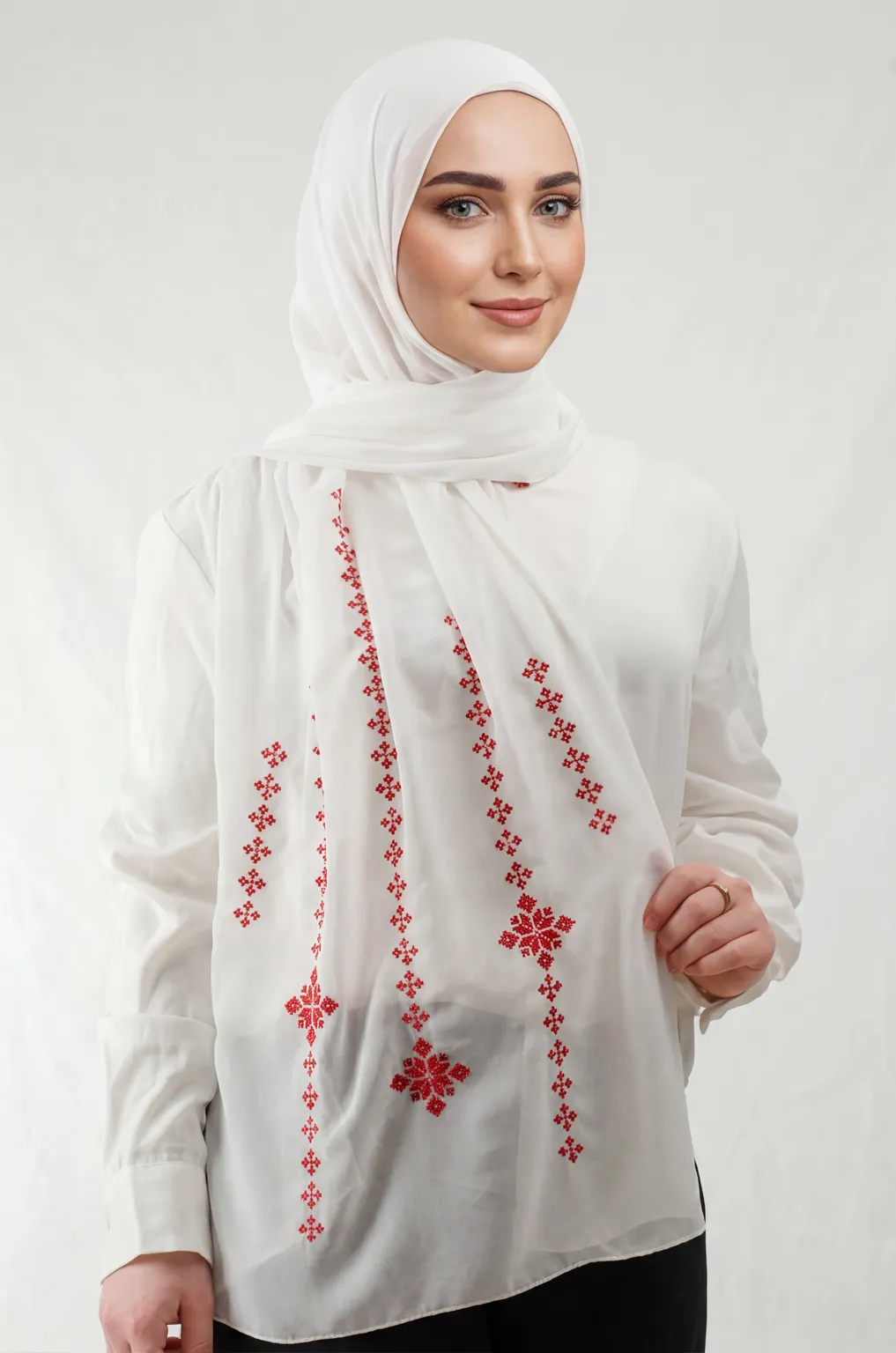 The Cream-Red Taif Embroidered Shawl features elegant red fallahi embroidery on a soft cream chiffon base with refined aghabani detailing. This embroidered shawl offers graceful movement and versatile styling while celebrating the beauty of Palestinian تطريز.
