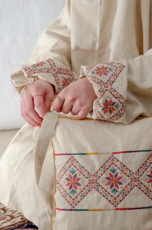 A beige 3-piece Tarteel embroidered prayer set featuring soft fabric and Fallahi embroidery inspired by handcrafted tradition. Designed for serene, elegant prayer moments.