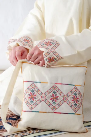 A cream 3-piece Tarteel embroidered prayer set featuring soft fabric and Fallahi embroidery inspired by handcrafted tradition. Designed for serene, elegant prayer moments.