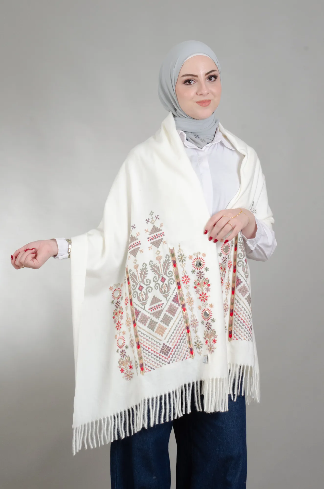 Ivory Nabati with Olive Mix shoulder shawl worn over the shoulders, showing the Falahi embroidery and fringed edge