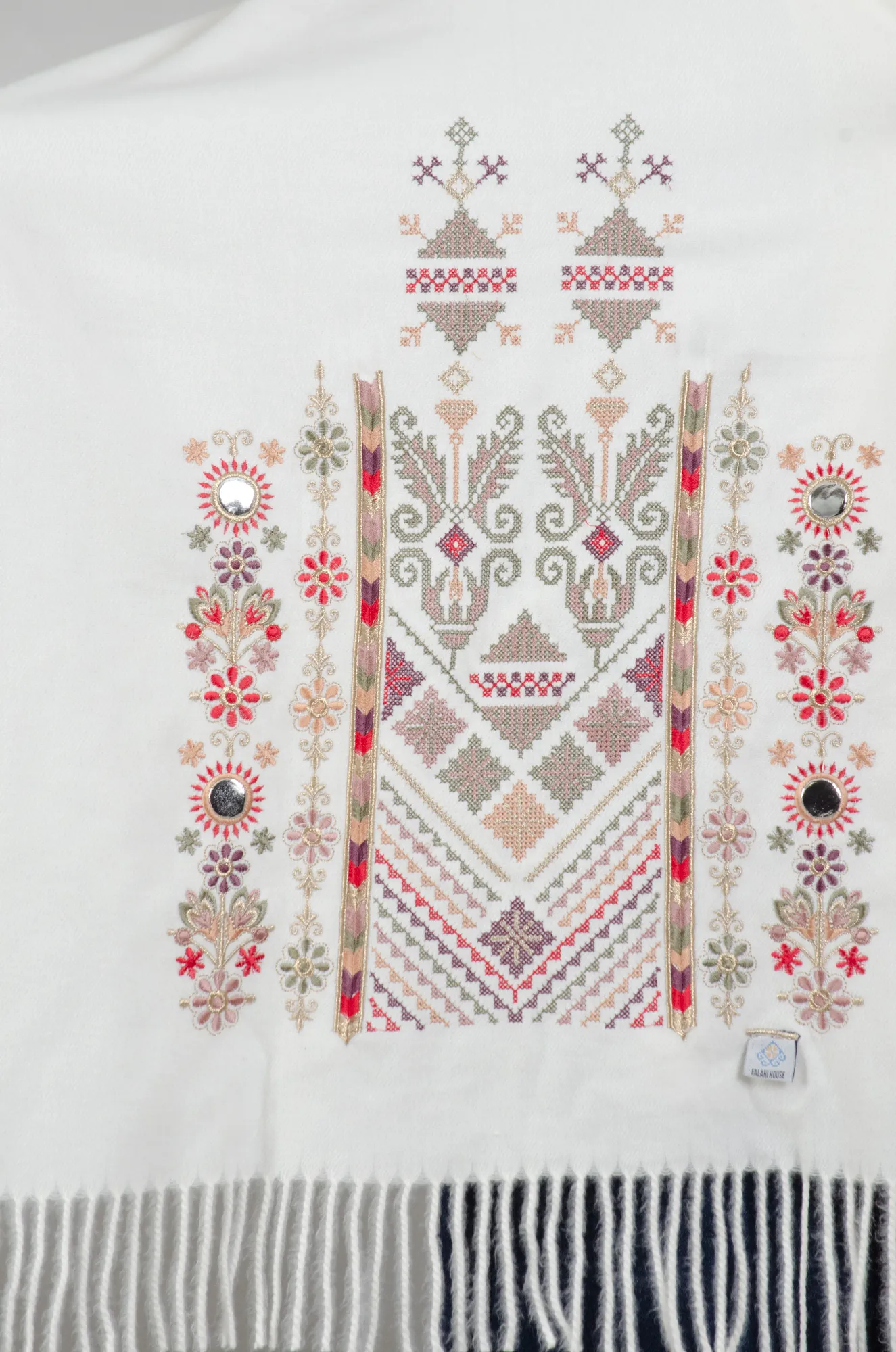 Close view of the Falahi embroidery, bratto stitching and mirror accents on the Ivory Nabati with Olive Mix shoulder shawl