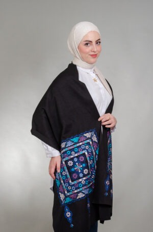 Model wearing black Tahreereh Indigo-Purple shoulder shawl with royal blue, turquoise and purple floral medallion embroidery
