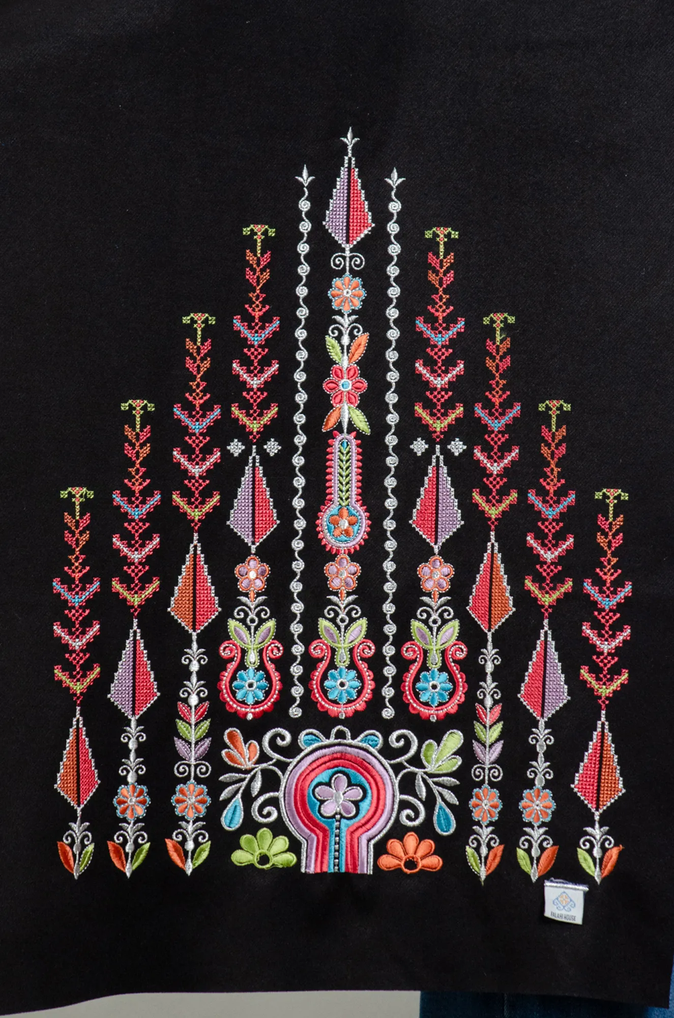 Close-up of candy mix Al-Saa'ah arch and floral embroidery in pink, sky blue and lime green